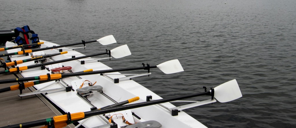 A boat with white blades ready at the pontoon in the morning mist